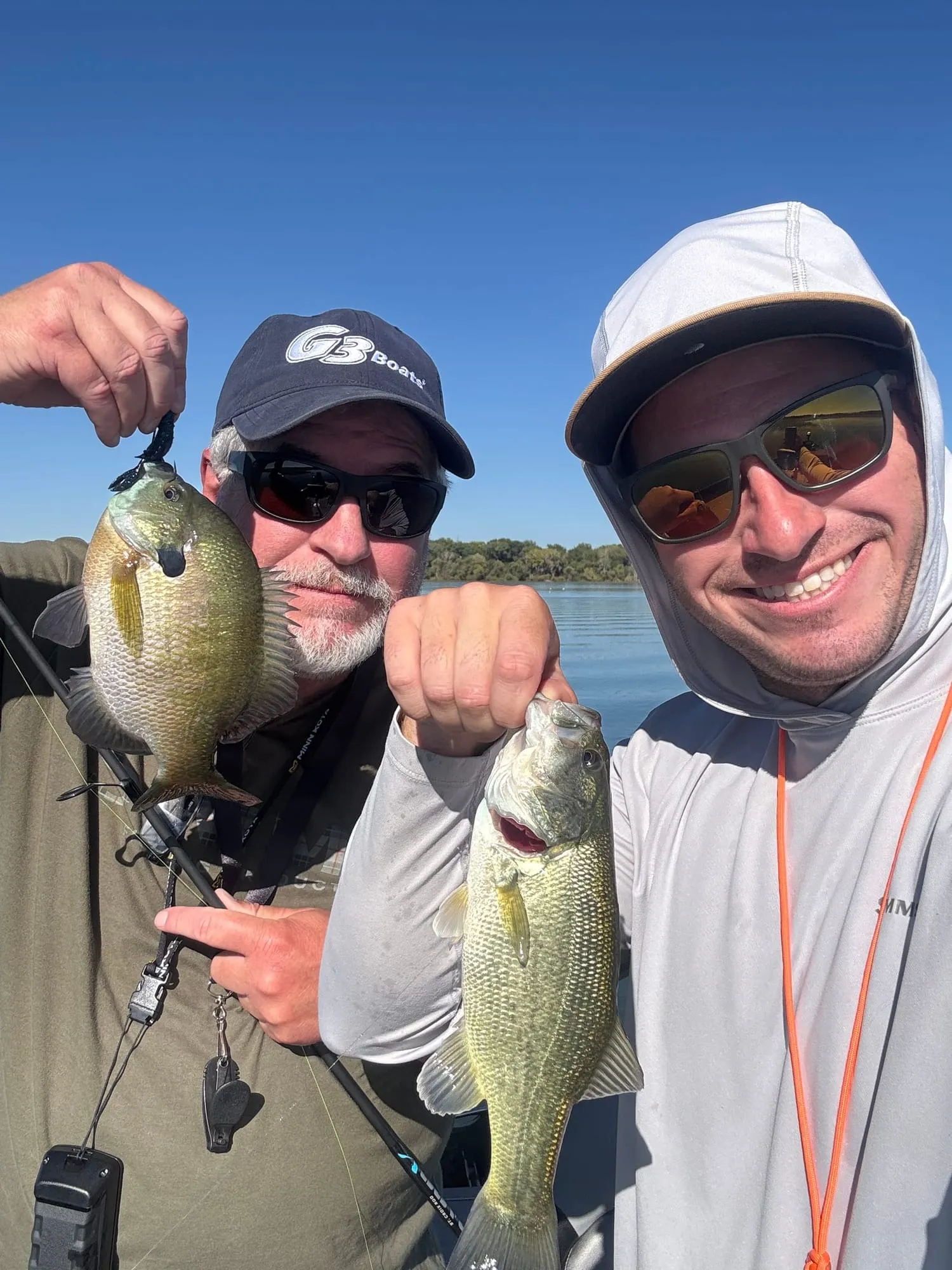 Holding up a pair of crappie on the lake
