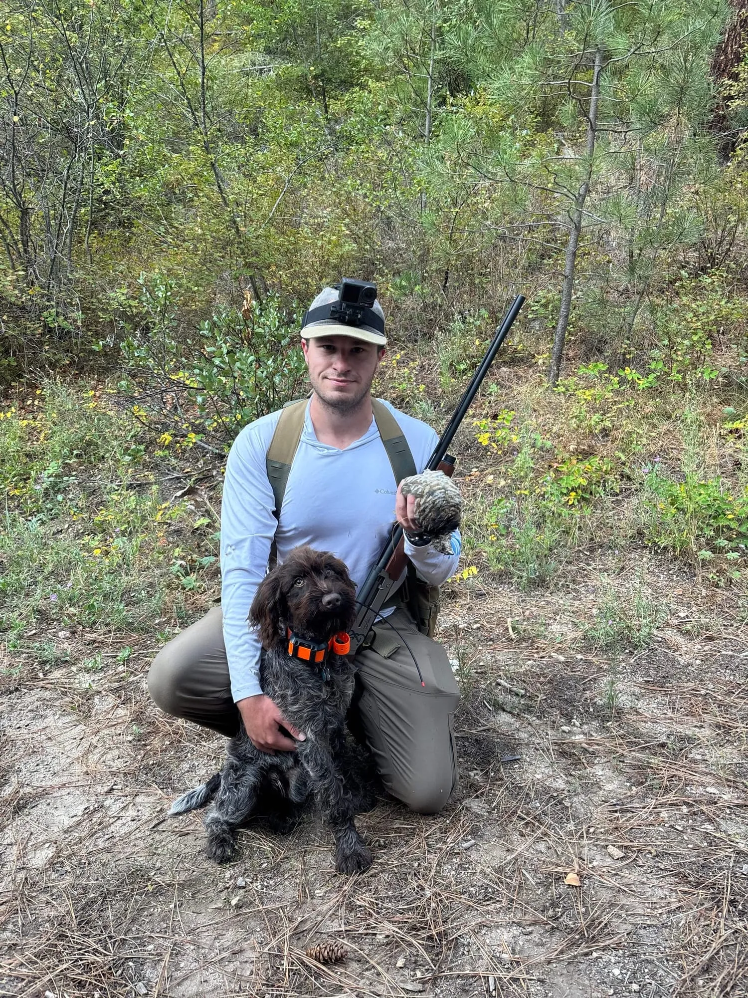 Kneeling with the dog and a shotgun
