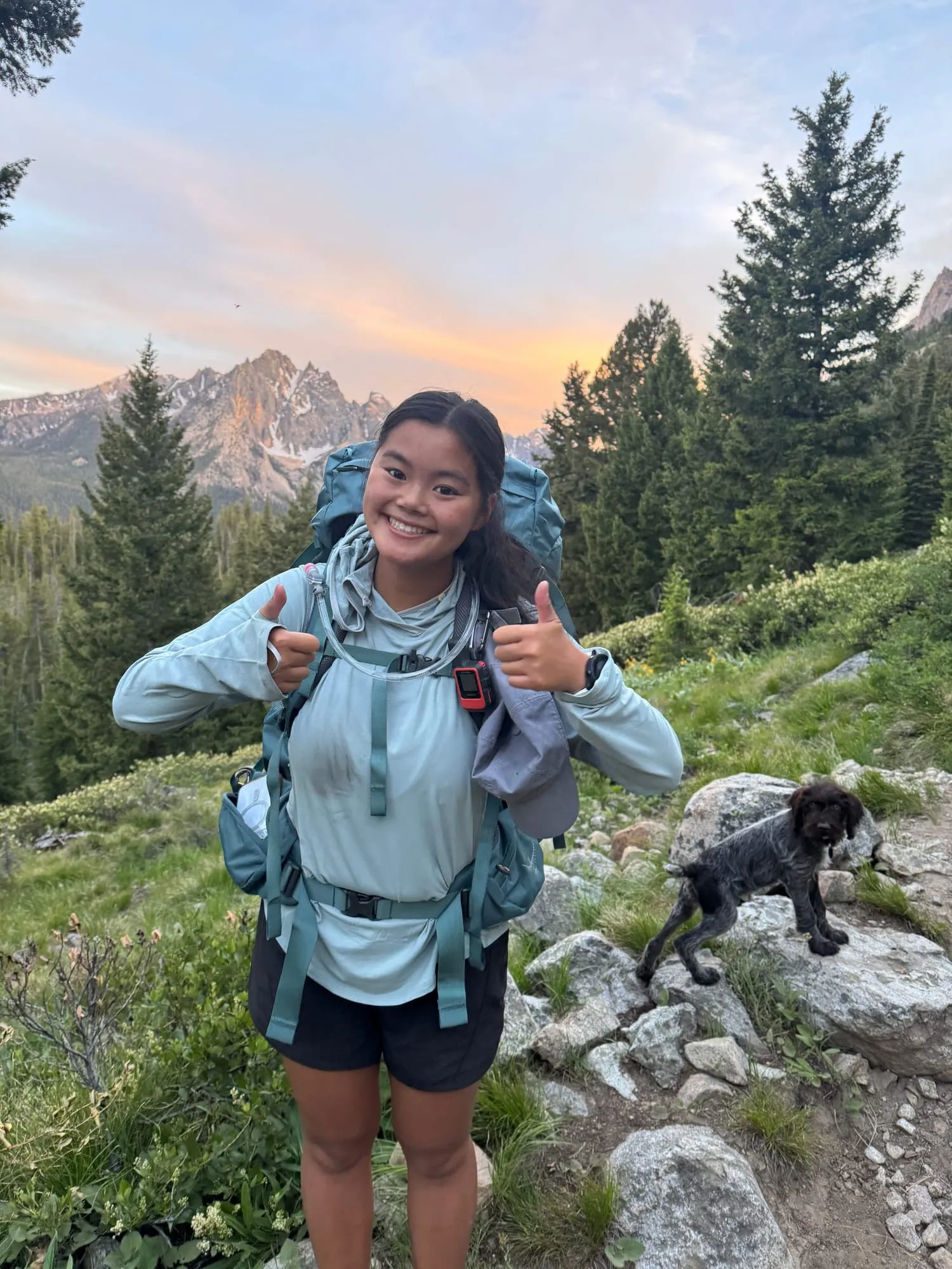 Hiking a mountain trail with a puppy at sunset