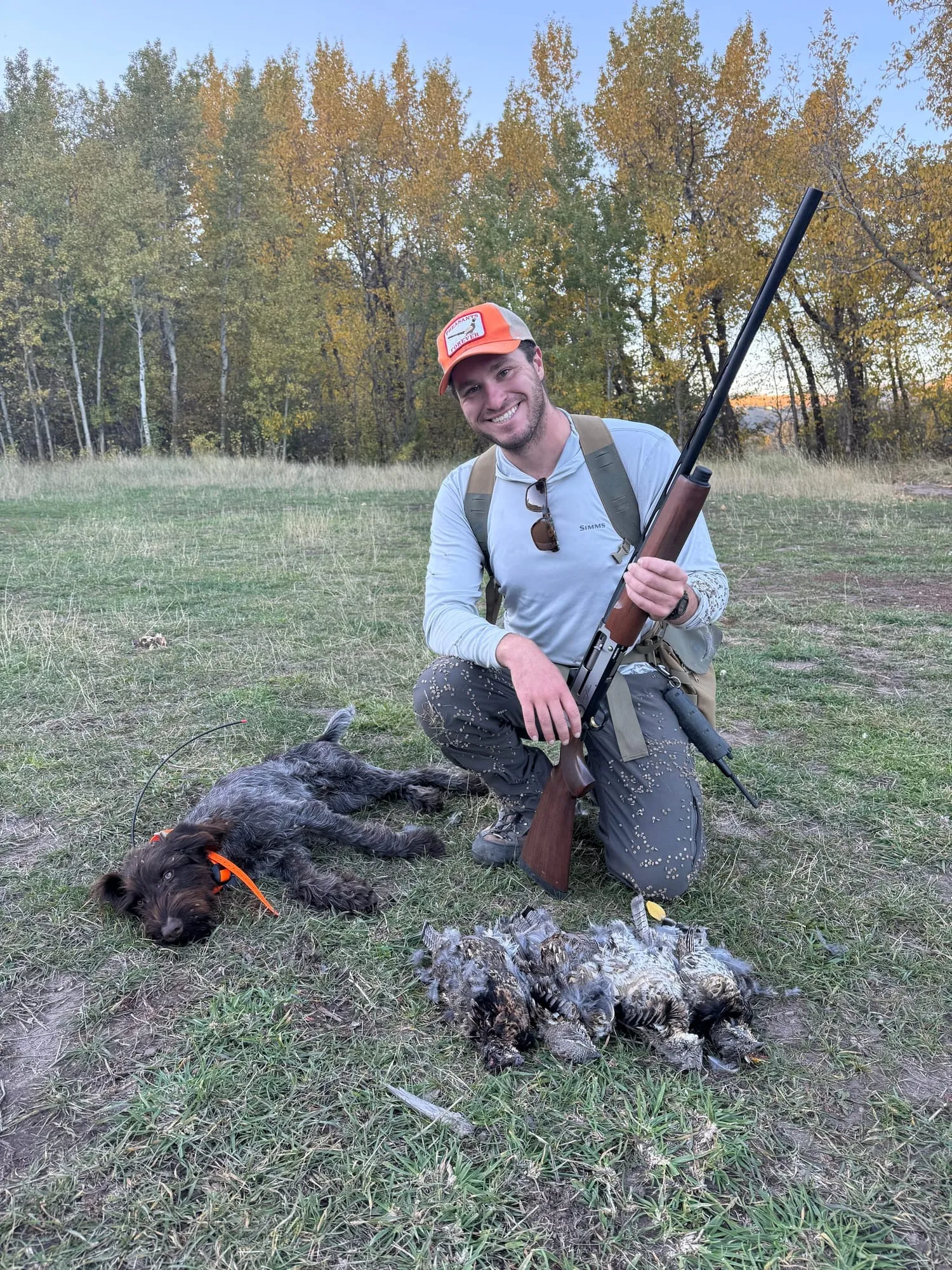 Kneeling with the shotgun and a day’s birds