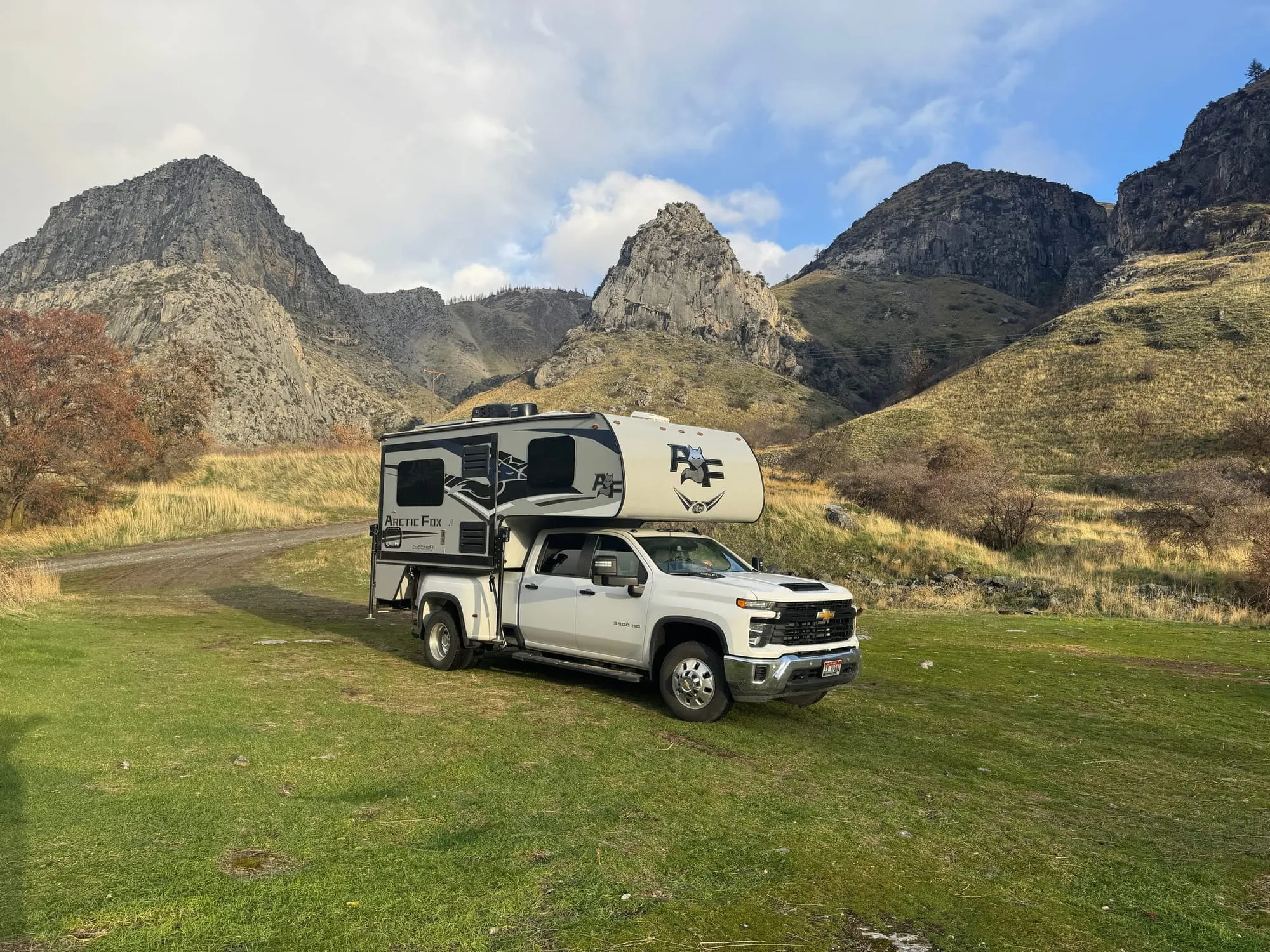 The truck camper below jagged peaks