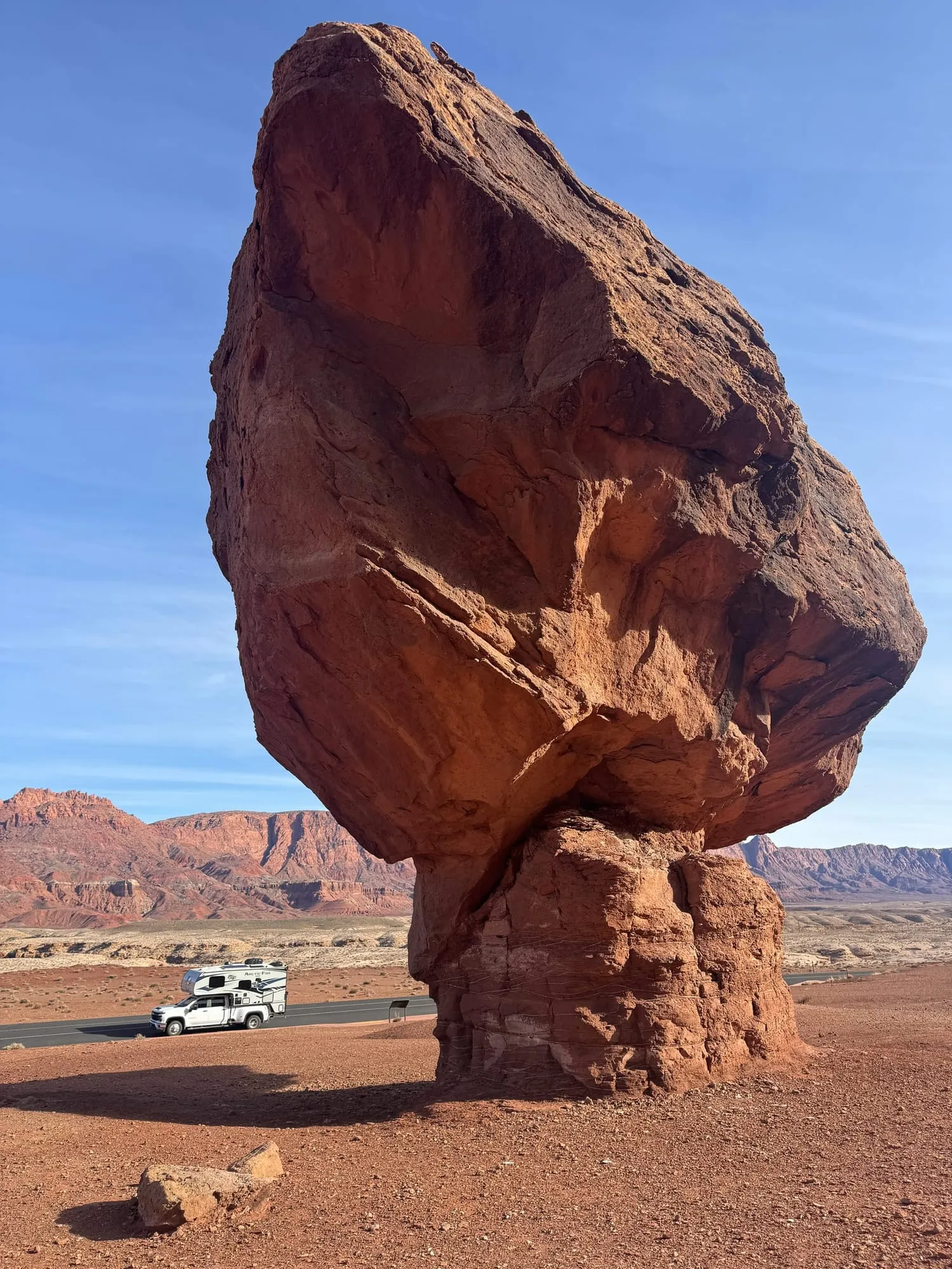 A balanced rock with the camper far below