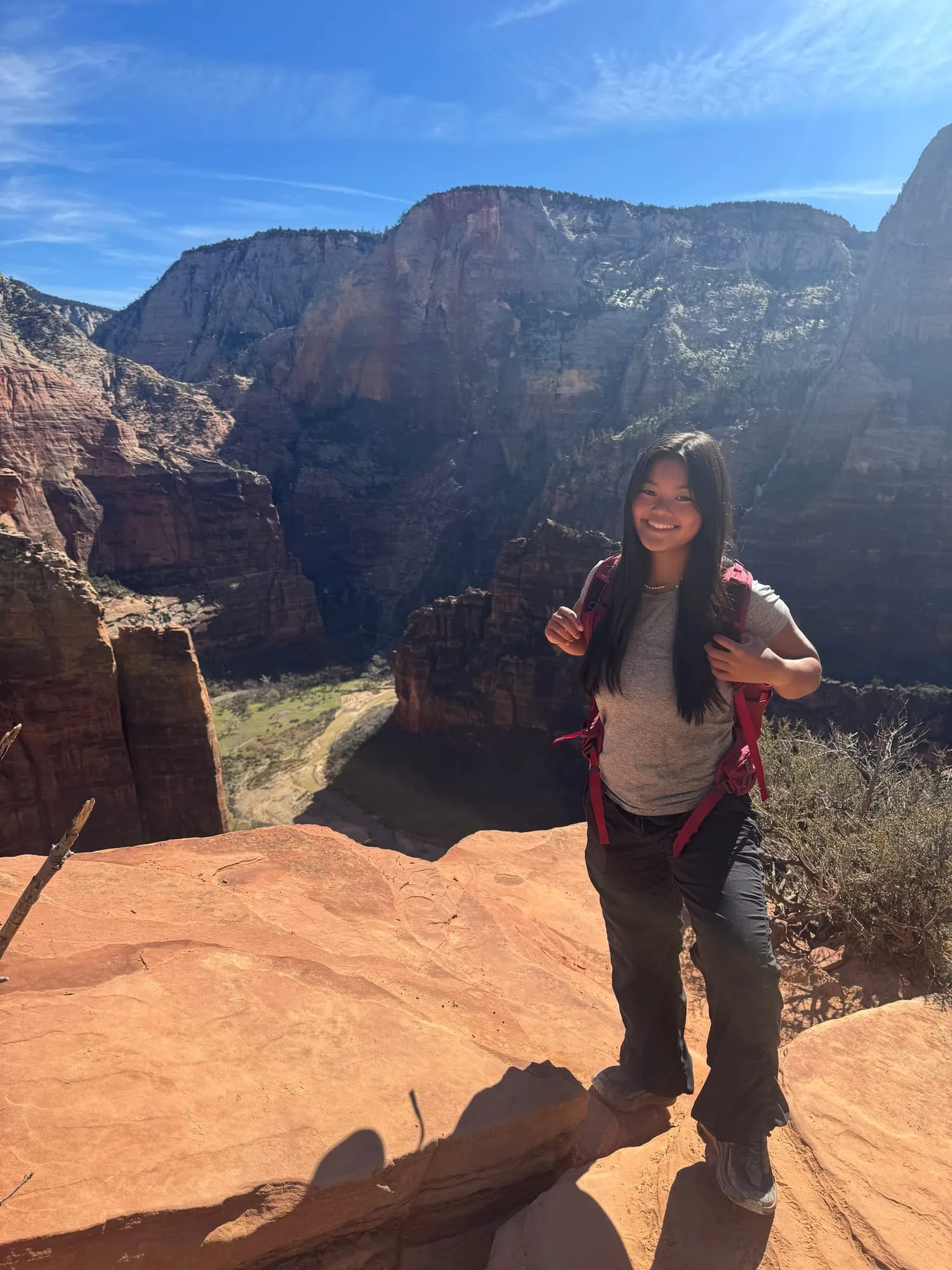 Standing on a red rock ledge in the canyon